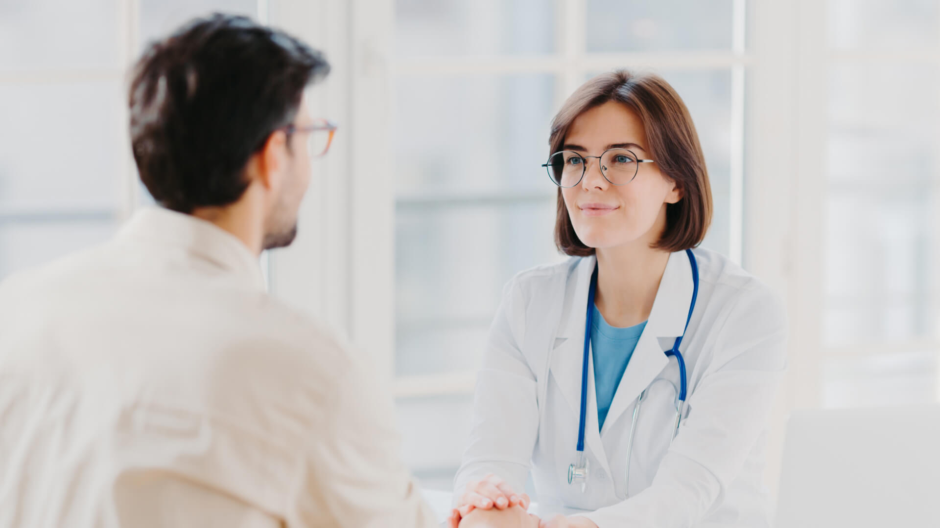a female doctor is talking to a male patient